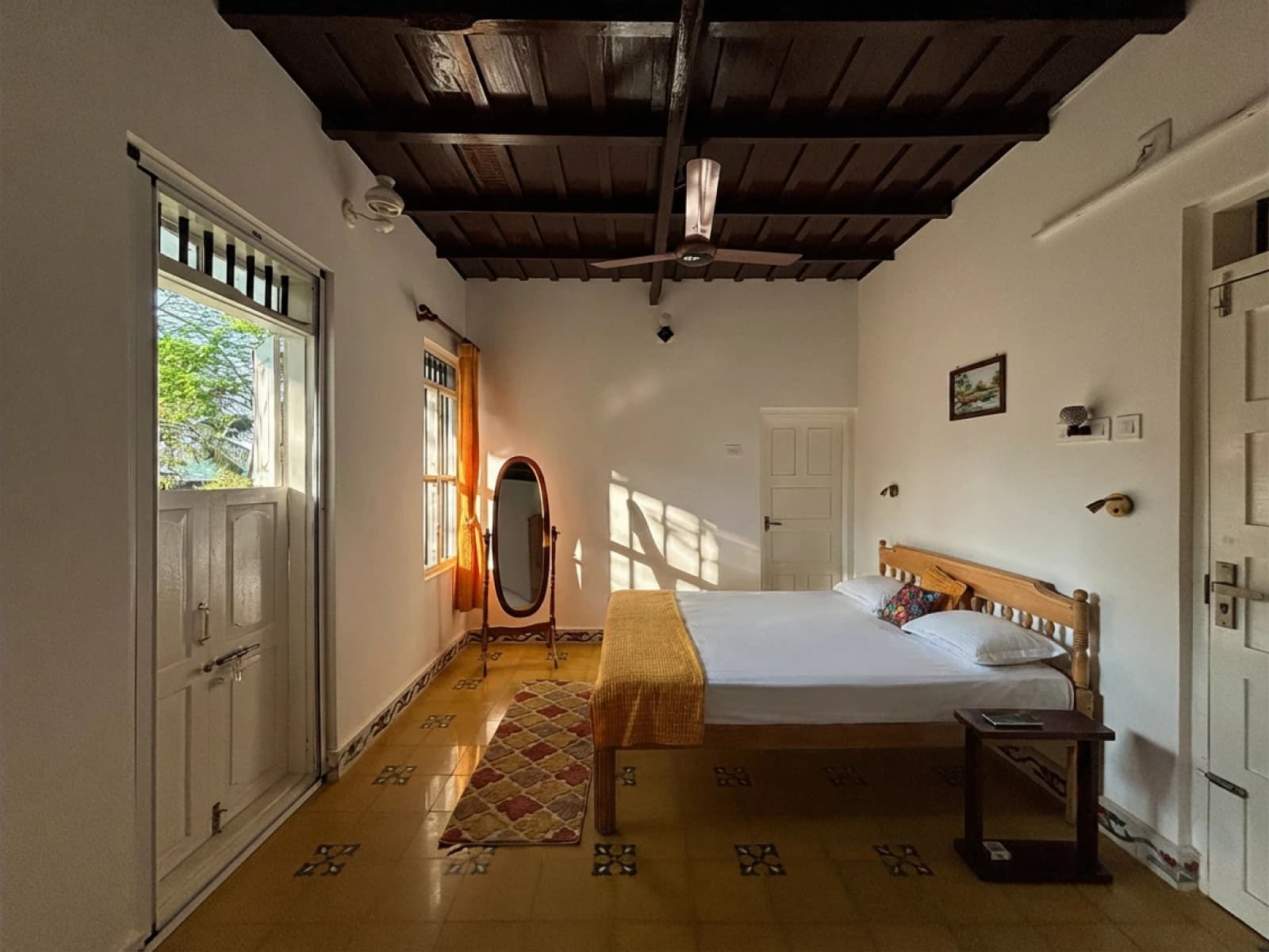 Mango Room — full room view with bed and natural light